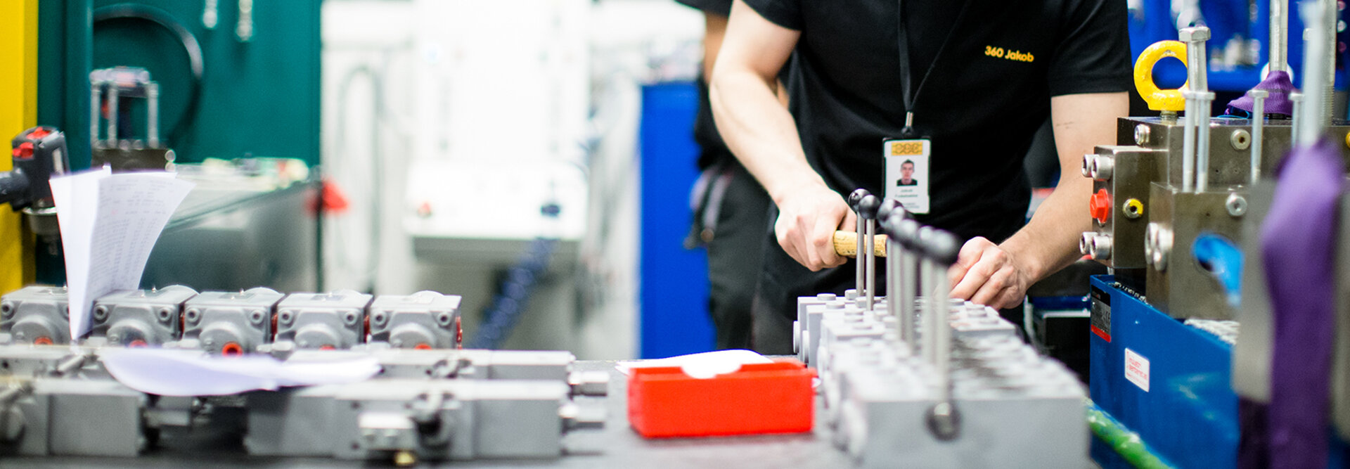 Ansatt som jobber med ventil Bilde av en ansatt som arbeider med en ventil, med verktøy og utstyr i nærheten