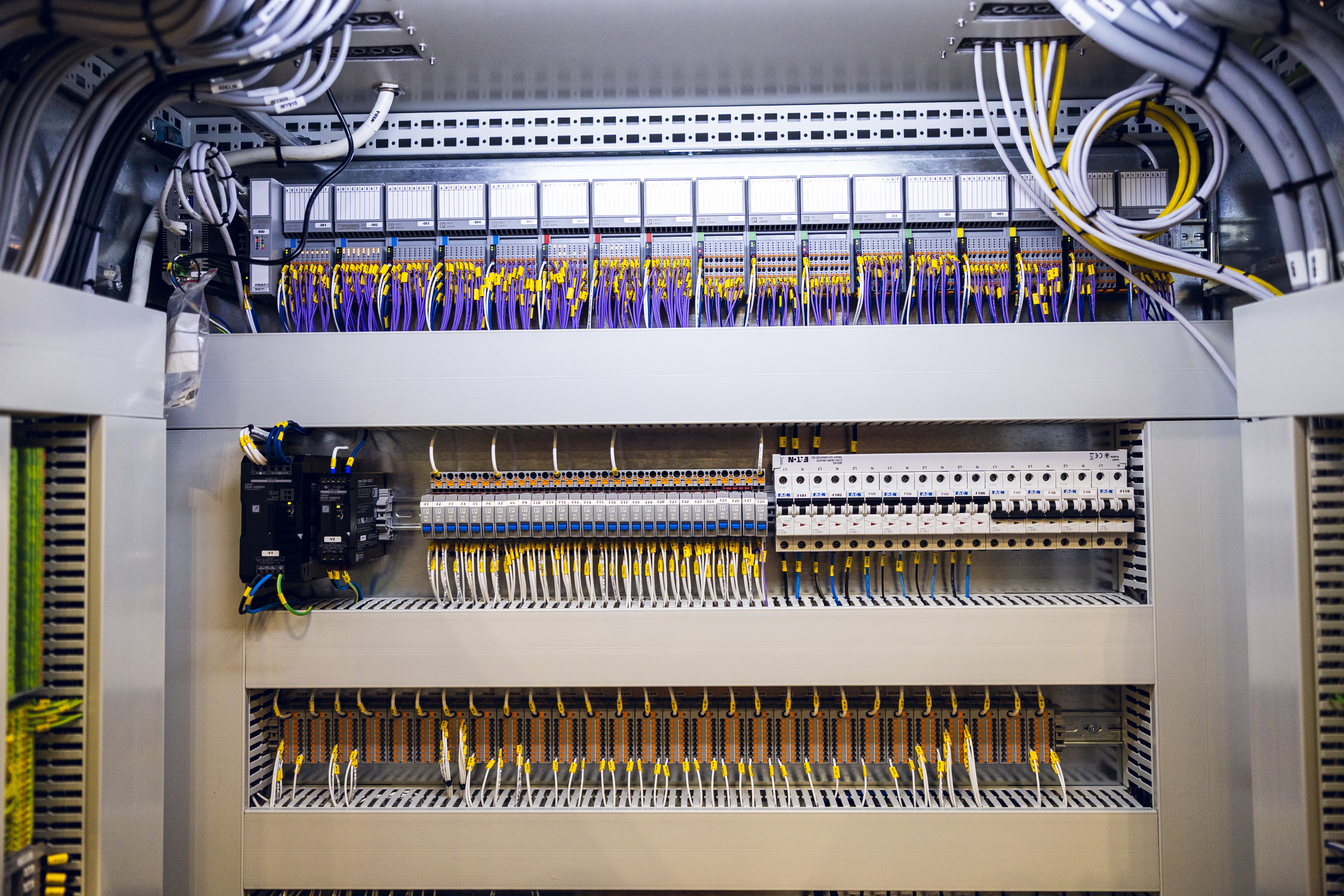 The interior of a large electrical cabinet packed with components, wiring, and connections | © Øyvind Welle
