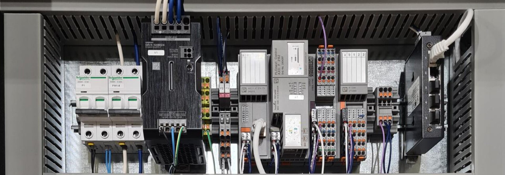 A close-up image of an electrical cabinet showing detailed electrical components and wiring