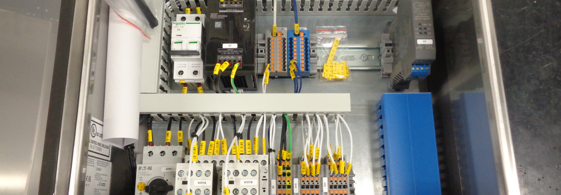 A close-up image of an electrical cabinet showing detailed electrical components and wiring.