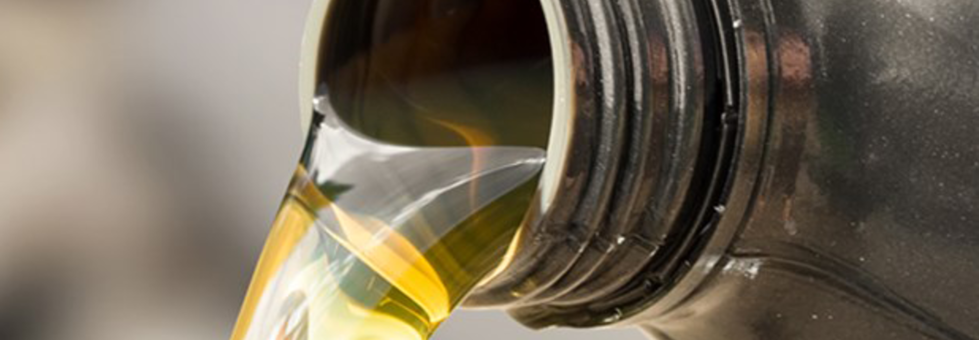 Image of biodegradable hydraulic oil pouring from a canister