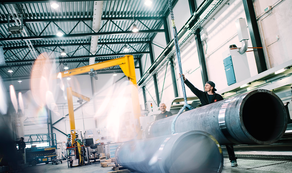 Two workers handling a cylinder at the factory in Rissa