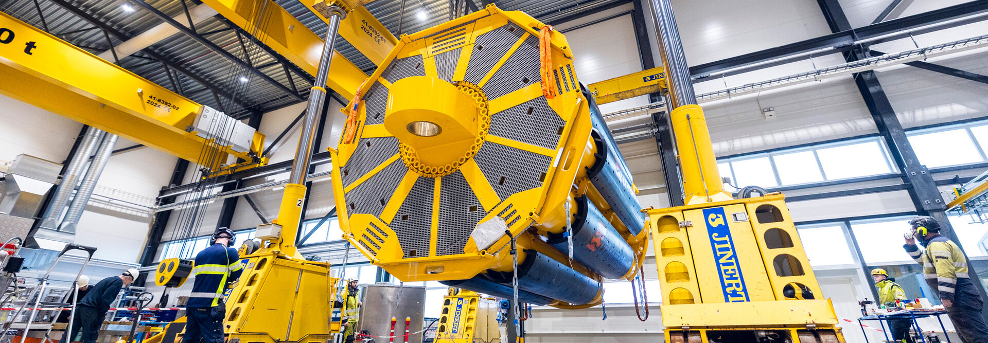 Cranemaster being lifted by crane inside the production hall of Servi Group